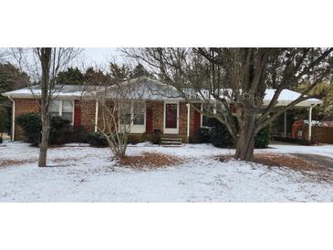 Brick ranch home with red shutters, covered porch, and snow-covered yard at 201 Providence Rd, Oxford, NC 27565