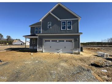 Two-story house with gray siding, white garage door, and landscaping at 53 Barony Ln, Smithfield, NC 27577