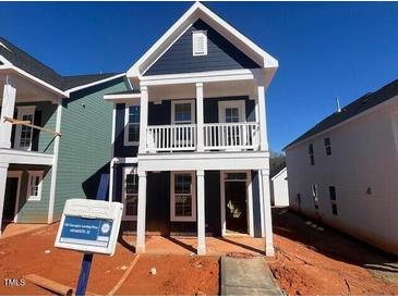 Two story home featuring a covered porch, multiple windows, and blue vinyl siding at 720 Georgias Landing Pkwy # 11, Raleigh, NC 27603