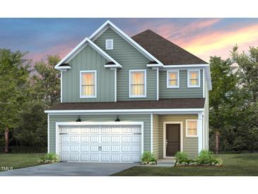 Two-story house with light green vinyl siding, white trim, and a two-car garage at 1013 Freestone Rd, Durham, NC 27703