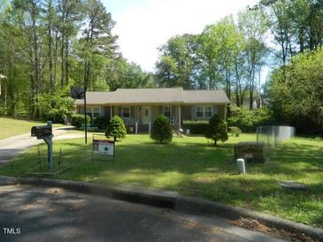 Charming single-story home with a well-manicured lawn and mature trees at 108 Cheney Ct, Garner, NC 27529