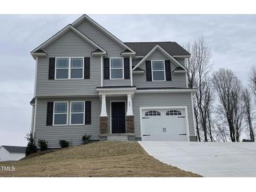 Two-story house with gray siding, black windows, and a two-car garage at 209 Constellation Ct, Benson, NC 27504