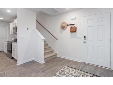 Bright entry with stairs, wood-look floors, and coat rack at 2184 Monk Dr, Haw River, NC 27258