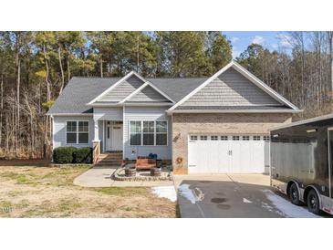 Gray siding two-story house with a white door and attached two-car garage at 46 Trusting Ln, Middlesex, NC 27557