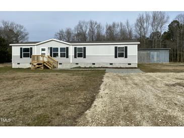 Single-wide manufactured home with detached shed and gravel driveway at 1039 Branch Chapel Church Rd, Selma, NC 27576
