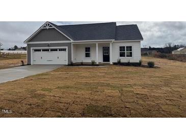 Charming single-Gathering home features a two-car garage, gray accents, and a well-manicured lawn at 135 Jones Creek Ln Ln, Lillington, NC 27546