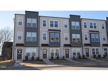 Three-story townhouses with modern design, neutral colors, and landscaping at 1928 Robin Hill Ln, Raleigh, NC 27610