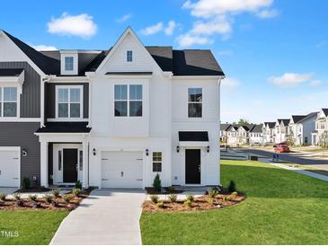Charming two-story home with landscaped yard, driveway, and attached garage, offering a welcoming curb appeal at 51 Pansy Park # 234, Clayton, NC 27520