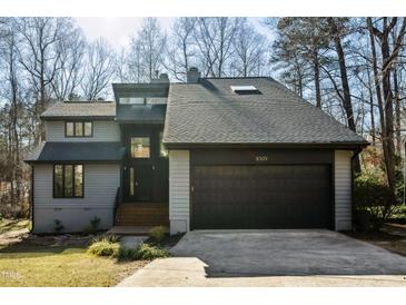 Modern two-story house with gray siding, black garage door, and landscaped lawn at 8309 Stryker Ct, Raleigh, NC 27615