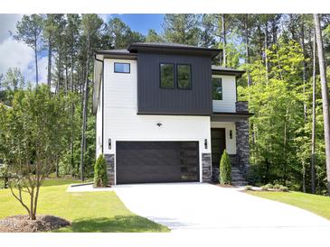 Two-story modern home with white and dark gray siding, stone accents, and a two-car garage at 914 Ardmore Dr, Durham, NC 27713