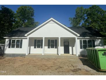 Charming new construction featuring a welcoming front porch and classic white siding at 132 Black Cloud Dr, Louisburg, NC 27549