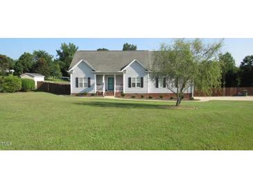 Charming one-story home with a well-manicured lawn, dark shutters, and inviting front porch at 35 Meadow Ln, Franklinton, NC 27525
