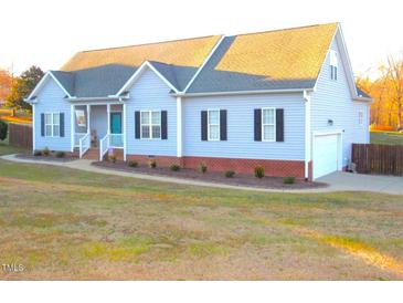 Charming single-story home with light blue siding and a well-manicured front lawn at 35 Meadow Ln, Franklinton, NC 27525