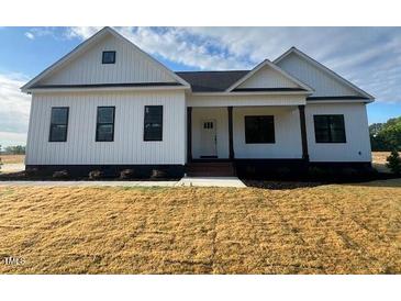 Charming single-story home with white siding and manicured lawn at 541 Delma Grimes Rd, Coats, NC 27521