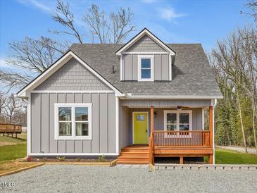 Charming gray home with a cozy front porch and a bright yellow front door at 624 S Eighth St, Mebane, NC 27302