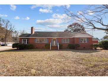 Brick ranch house with a spacious lawn and mature trees at 809 Jeffreys Rd, Rocky Mount, NC 27804