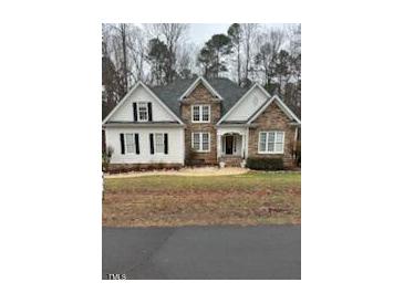 Traditional two-story home featuring brick and siding at 1201 Rivermead Ln, Wake Forest, NC 27587