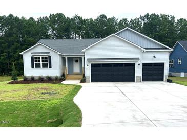 Newly constructed home with two-car garage and landscaped lawn at 250 Eason Creek Way, Clayton, NC 27527