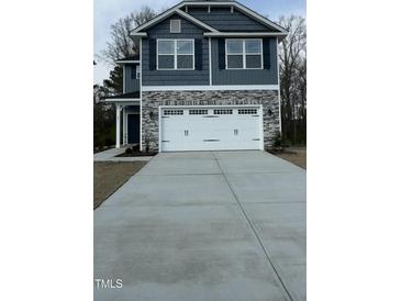 Exterior shows a two-car garage and a two-story home with gray siding and stone accents at 251 Hopewell Br Ct, Smithfield, NC 27577