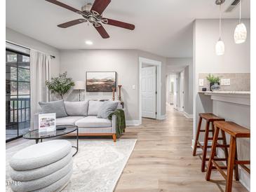 Bright living room with hardwood floors, comfy sofa, and a fireplace at 3805 Chimney Ridge Pl # 008, Durham, NC 27713