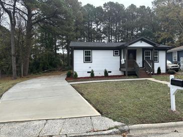 Newly renovated home with a long driveway and landscaped yard at 401 Commonwealth St St, Durham, NC 27703