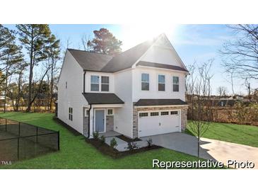Two-story house with gray and white exterior, two-car garage, and landscaped lawn at 292 Nathan Dr # 46P, Lillington, NC 27546