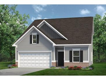 Two-story craftsman style home with gray siding, brick accents, and a two-car garage at 14 E American Marigold Dr # 65, Benson, NC 27504