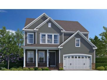 Two-story house with gray siding, white garage door, and a front porch at 3205 Armeria Dr, Apex, NC 27502