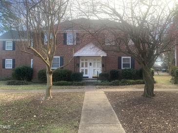 Traditional red brick apartment building featuring black shutters and white awning over the entry at 943 St Marys St # B, Raleigh, NC 27605