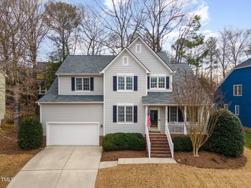 Two-story house with gray siding, brick accents, and a white garage door at 13116 Townfield Dr, Raleigh, NC 27614