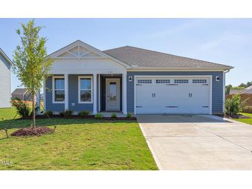 Newly constructed home with two-car garage and attractive landscaping at 133 Barn Door Dr, Lillington, NC 27546
