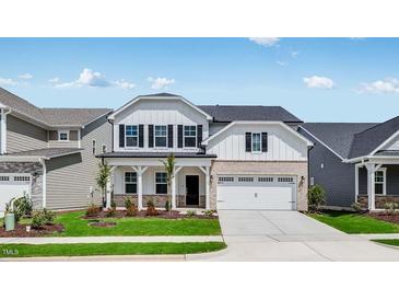 Charming two-story home featuring a well-manicured lawn and a welcoming front porch at 1705 Clydner Dr, Cary, NC 27523
