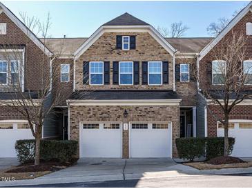 Brick front exterior of charming townhome with two-car garage at 222 Kylemore Cir, Cary, NC 27513
