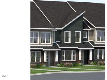 Charming townhome exteriors feature varied siding, black roofs, and manicured landscaping at 3021 White Rail Dr, Fuquay Varina, NC 27526