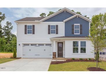 Two-story house with white and blue siding, a two-car garage, and a landscaped lawn at 37 Baird Cv Ln, Angier, NC 27501