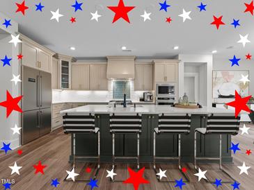 Beautiful kitchen with light cabinets, stainless steel appliances, and spacious island with seating at 645 Silvercomet Dr, Knightdale, NC 27545