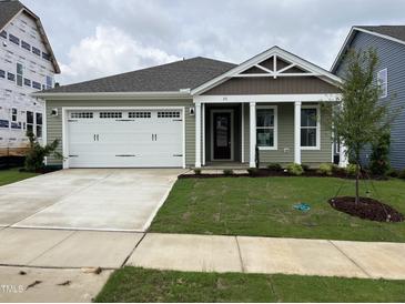 Newly constructed home with a two-car garage and well-manicured lawn at 76 Brooklynn Trl, Angier, NC 27501