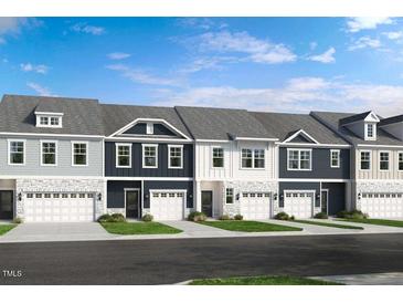 Charming townhome complex with stone accents, attached garages, and coordinated color schemes at 8705 Wardle Ct, Wake Forest, NC 27587