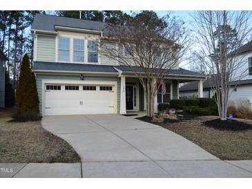 Charming two-story home with a two-car garage and landscaped front yard with tasteful plantings at 104 Warm Wood Ln, Apex, NC 27539