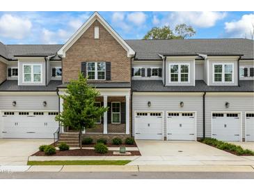 Brick front townhome with 2-car garage and landscaped yard at 1135 Laurelwood Dr, Durham, NC 27705