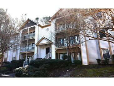 Two-story condo building with multiple balconies and landscaping at 1511 Creekwood Ct # 102, Raleigh, NC 27603