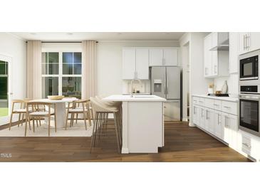 Bright kitchen with island, stainless steel appliances, and breakfast area at 1540 Goldfinch Perch Ln, Knightdale, NC 27545