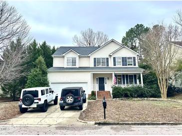 Charming two-story home with a manicured lawn and attached two car garage on a tree-lined street at 2421 Barton Oaks Dr, Raleigh, NC 27614
