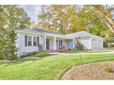 Gray house with a front porch and attached two-car garage at 4034 S Mcdowell, Pittsboro, NC 27312
