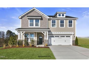 Two-story house with gray siding, stone accents, and a two-car garage at 93 Macy Cir, Wendell, NC 27591