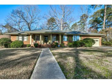 Brick ranch house with covered porch and landscaped yard at 108 Pinewood Ave, Rocky Mount, NC 27804