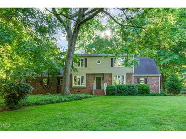 Charming two-story home with lush lawn and mature trees at 11712 Black Horse Run, Raleigh, NC 27613