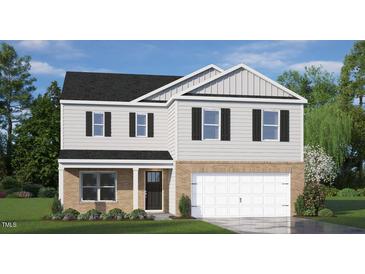 Two-story house with gray siding, brick bottom, and a two-car garage at 15 Granite Falls Way, Youngsville, NC 27596