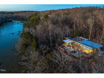 Stunning architectural home featuring a solar panel roof and beautiful natural riverfront surroundings at 196 Paces Mill Trl, Pittsboro, NC 27312