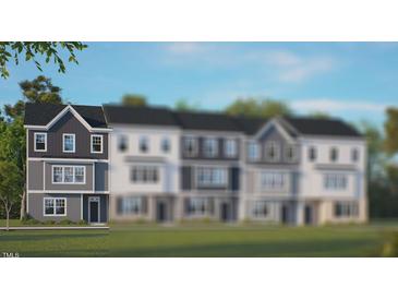 Two-story townhome with gray siding, white trim, and a grassy lawn at 2259 Horton Park Dr, Apex, NC 27539